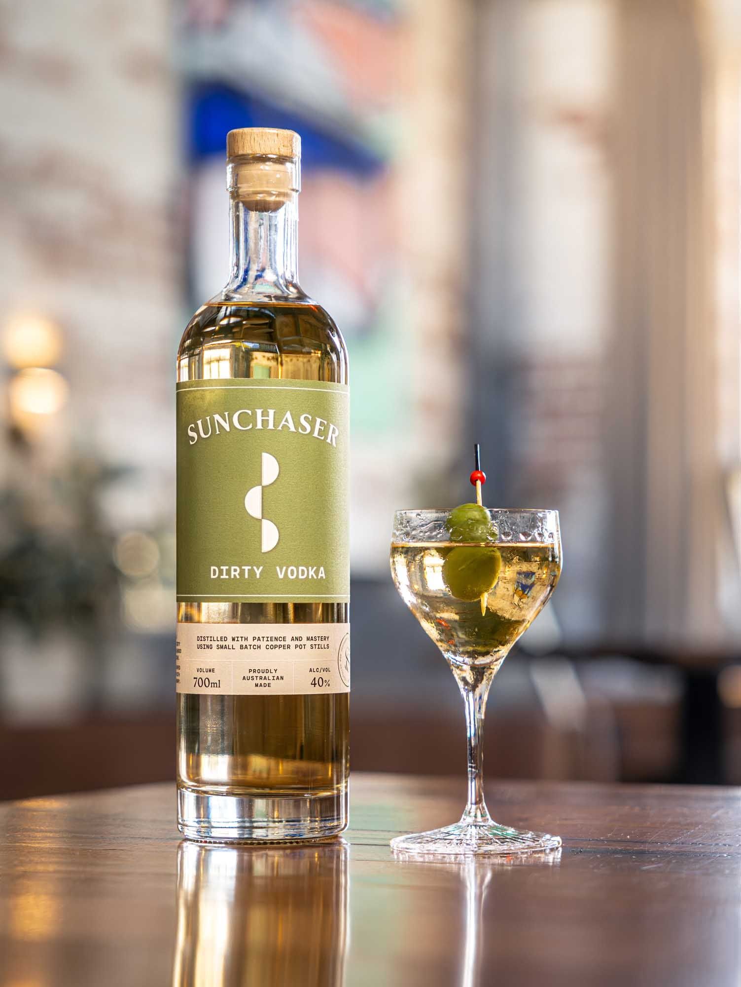 A Sunchaser Dirty Martini garnished with olives.